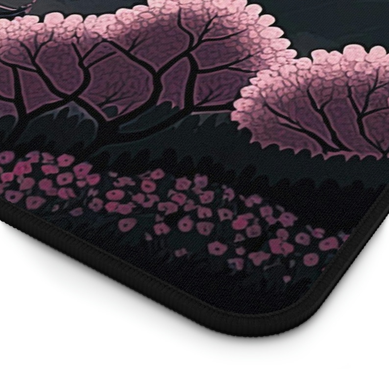 A zoomed in view of the bottom right corner of the desk pad illustrates where the artwork hits the hem.