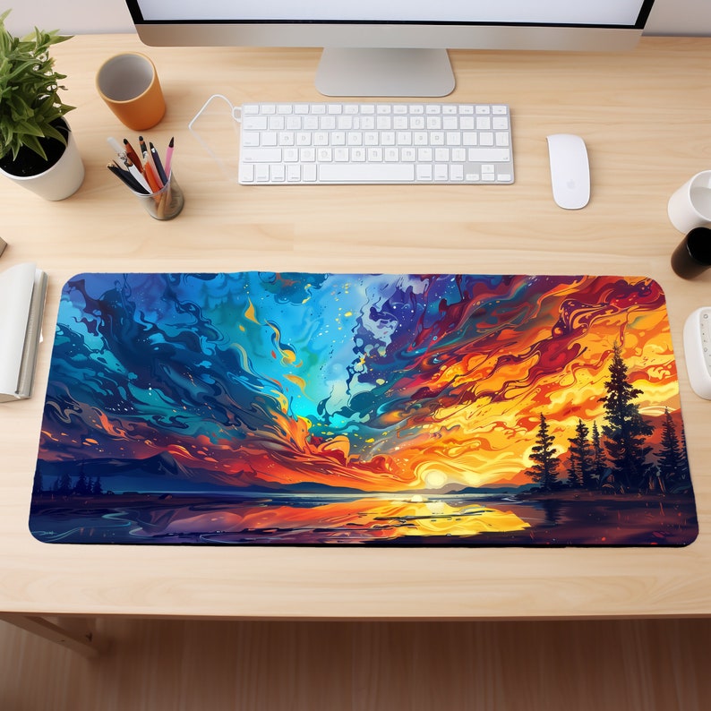 May include: A colorful abstract sunset scene with a lake and trees in the foreground. The sky is a mix of blue, orange, yellow, and red with swirling clouds. The image is perfect for a desk mat or mouse pad.