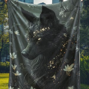 May include: A black wolf with glowing eyes and white flowers is featured on a dark gray fleece blanket.