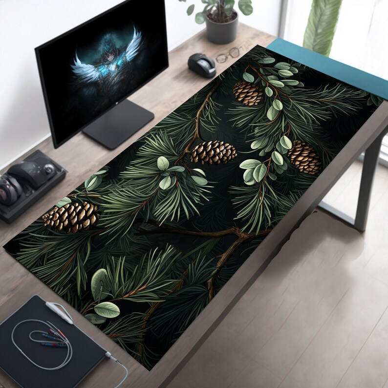 May include: A dark green and black mousepad with a pine branch and pine cone design. The pine cones are gold and brown.