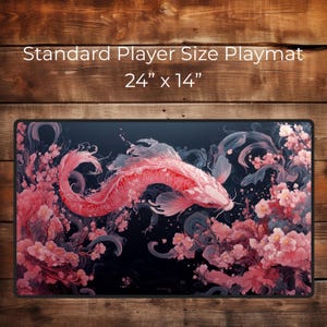 May include: A pink and white koi fish swims through a field of pink cherry blossoms on a black background. The playmat is 24 inches by 14 inches.