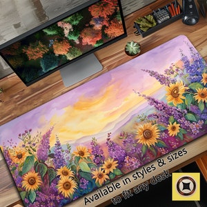 May include: A purple and yellow sunset landscape with a field of purple flowers and yellow sunflowers. The text "Available in styles & sizes to fit any desk" is at the bottom of the image.