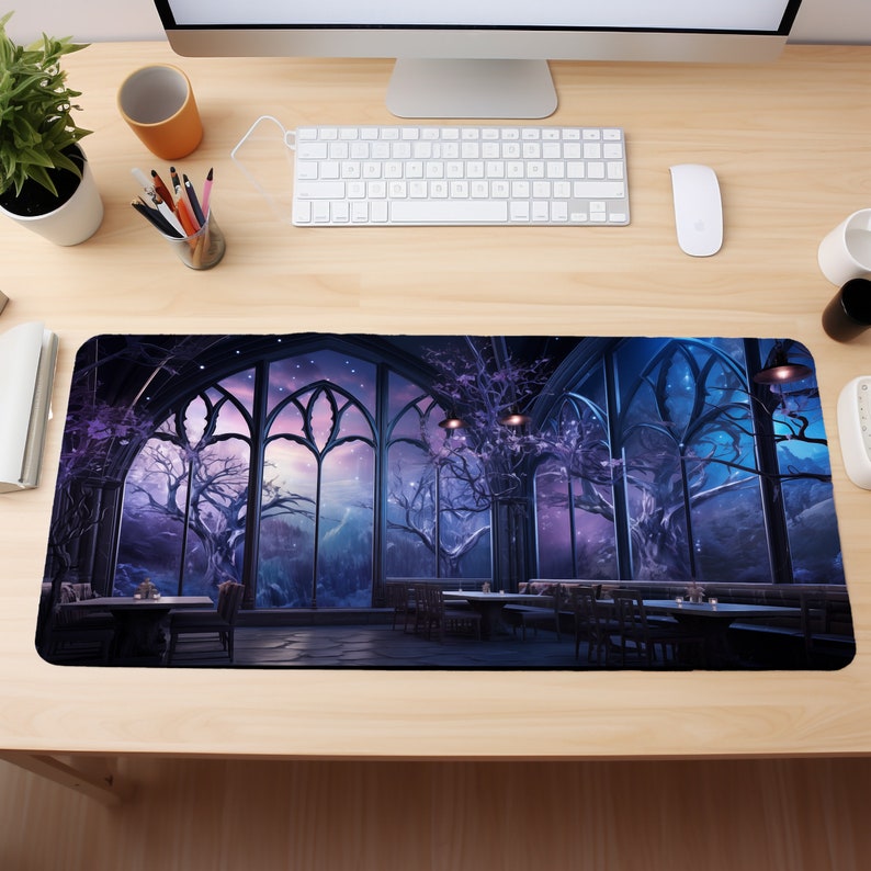May include: A large, dark purple and blue mousepad with a fantasy scene of a large, gothic window with a view of a forest and a starry night sky. The window is framed by black stone and has many arched windows. There are trees and a small building in the distance.