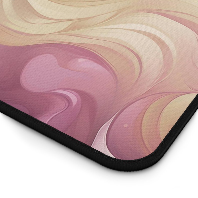 A zoomed in view of the bottom right corner of the desk pad illustrates where the artwork hits the hem.