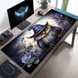 May include: A blue and purple owl wearing a witch's hat sits on a branch with purple flowers. The owl has large, yellow eyes and a detailed design. The background is a dark blue with white snowflakes.