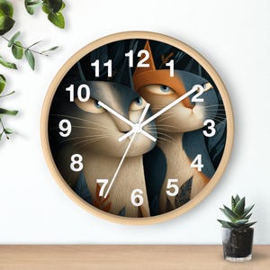 May include: A circular wall clock with a light wood surround. The clock face displays a cartoon illustration of two cats with blue and orange fur. The clock hands are white, and the numbers are black.