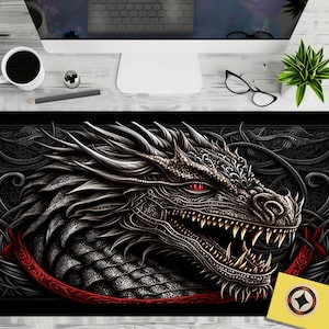 May include: A black and silver dragon head with red eyes, detailed with intricate patterns, against a dark background with a red ribbon.