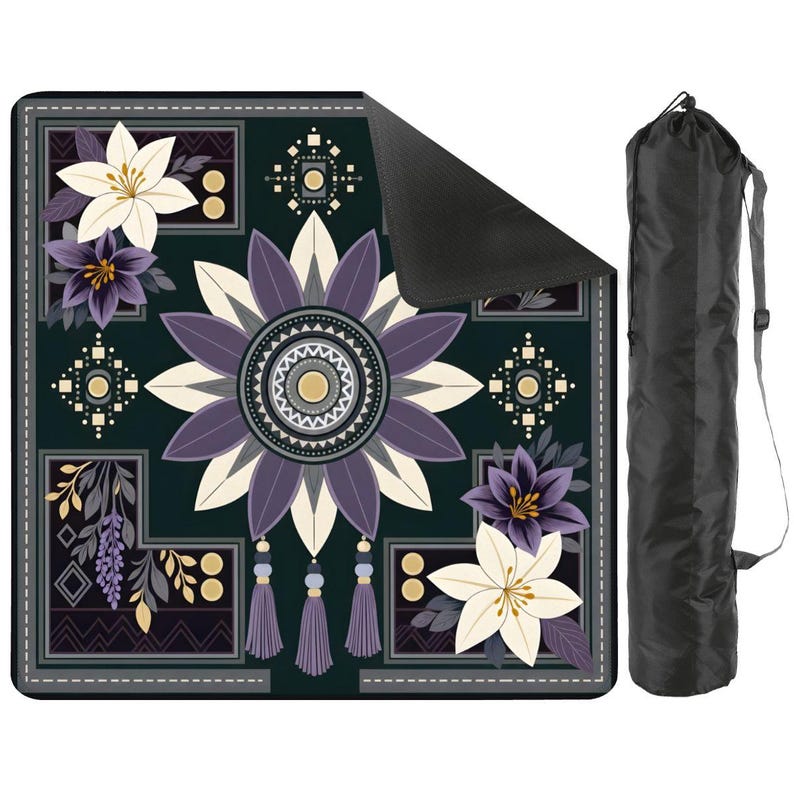 May include: A square mat featuring a dark green background with a central purple and cream floral mandala design, accented by corner lily clusters and hanging tassels. The mat has a black underside and comes with a black cylindrical carrying bag.