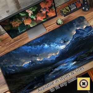 May include: A blue and black desk mat with a starry night sky and mountain range scene. The text "Available in styles & sizes to fit any desk" is at the bottom of the mat.