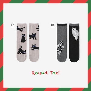 May include: Two pairs of socks with different designs. The first pair is grey with black cats. The second pair is grey with a black and white owl and black with a white owl. The text "Round Toe!" is printed below the socks.