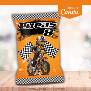 May include: Orange party favor bag with a motocross theme. The bag features a cartoon illustration of a motocross racer on a motorcycle, checkered flags, and the name "Lucas 8". The bag is decorated with a black and white checkered pattern.