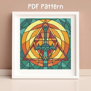 May include: A cross-stitch pattern featuring a stained glass design of a sword in a triangle surrounded by a circle. The colors are a mix of orange, yellow, green, and blue.