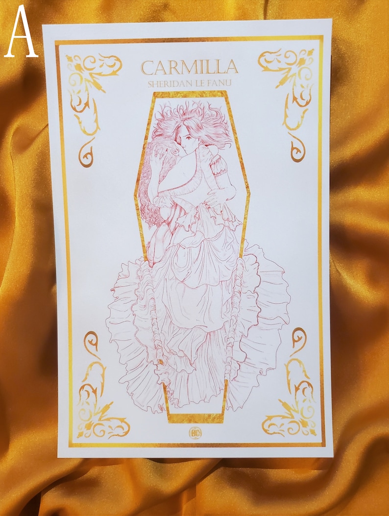May include: A white print with a gold border featuring a line drawing of a woman in a coffin. The title "Carmilla" and the author "Sheridan Le Fanu" are printed in gold at the top of the print.