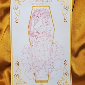 May include: A pink and gold print of a woman in a long dress, with the title "Carmilla Sheridan Le Fanu" at the top.