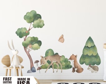 May include: A set of watercolor-style wall decals featuring a deer, fox, hedgehog, bird, butterfly, and trees. The decals are perfect for a nursery or child's room.