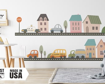 May include: A colorful wall decal featuring a street scene with houses, cars, and trees. The decal includes a police car, a school bus, and a delivery truck. The text "STOP" is visible on a red stop sign.