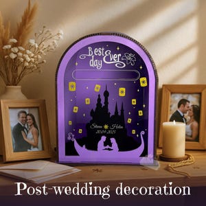 The elegant purple color is the main focal point of the product's design.

The box is placed next to other fairytale-themed wedding decor, like flowers or candles.