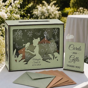 May include: A light green wooden card box with a princess silhouette design, a matching sign that reads "Cards and Gifts", and envelopes. The box has a slot on top and a clear front panel. The box is personalized with a name and date.