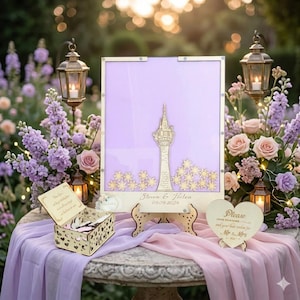 May include: A wedding guest book alternative with a laser-cut tower design, surrounded by star-shaped accents. The guest book is displayed on a table with a wooden box and a heart-shaped sign. The text on the guest book says "Steven & Helen 09.09.2024".