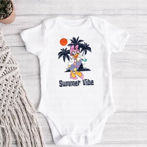 May include: White baby onesie with a cartoon duck wearing sunglasses and a pink bow. The duck is standing in front of palm trees and a setting sun. The text "Summer Vibe" is printed below the duck.