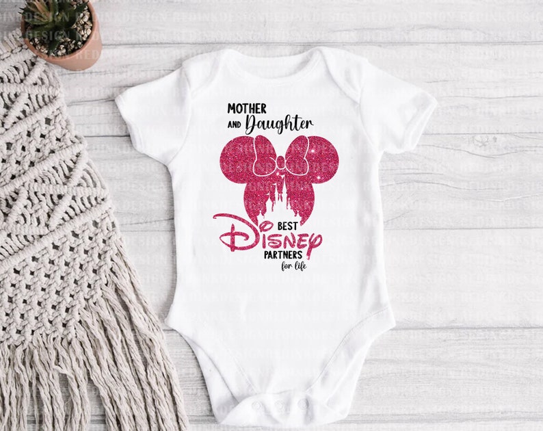 May include: White baby onesie with pink glitter Mickey Mouse ears and a castle graphic. The text reads "Mother and Daughter Best Disney Partners for Life."