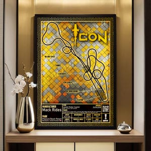 May include: A framed poster featuring a yellow and gray checkered background with a black line drawing of the Icon roller coaster track layout. The text includes technical specifications, the name Icon, and details about the Mack Rides manufacturer.