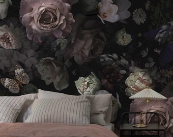 May include: A bedroom with a black floral wallpaper featuring pink roses, butterflies, and other flowers. A bed with a white and pink comforter and striped pillows is in the foreground. A black side table with a lamp and a book is next to the bed. The text "marWALlous" is on the bedspread.