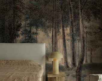 May include: A bedroom interior with a beige bed, a white armchair, and a bedside table with a lamp. The wall behind the bed features a large-scale wallpaper mural depicting a forest scene with trees and a stream.