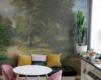 May include: A white round table with two pink velvet chairs and a black bench with yellow and white pillows. The table and chairs are in front of a wall mural depicting a landscape with trees and a path.