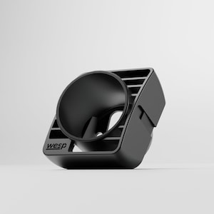 Könnte beinhalten: Schwarze Handyhalterung für die Lüftung im Auto mit rundem Halter und rechteckiger Basis. Auf der Basis steht "wesp". Die Halterung ist für die Befestigung eines Telefons an der Lüftung konzipiert.