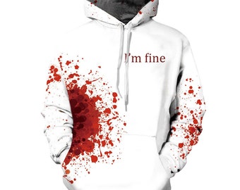Pode incluir: Moletom branco com capuz com um design de respingo de sangue vermelho e o texto "Estou bem" impresso na frente.