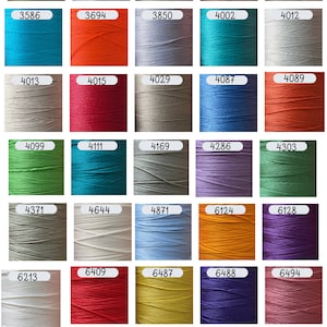 May include: A grid of forty-five spools of thread in various colors, each labeled with a unique four-digit number. The collection includes shades of blue, green, red, yellow, purple, pink, brown, gray, white, and orange, all arranged in rows.