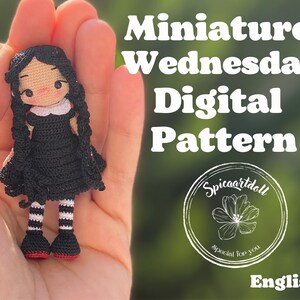 May include: A crochet doll pattern for a miniature Wednesday Addams doll. The doll is dressed in a black dress with a white collar and has black hair in braids. The pattern is available in English and is called "Miniature Wednesday Digital Pattern".