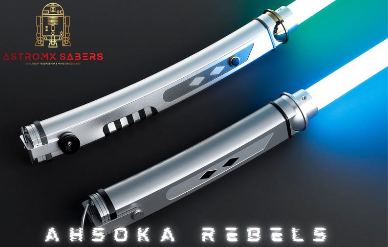 May include: Two silver lightsabers with glowing white and blue blades. The hilts have intricate designs with black accents and blue buttons. The text "AHSOKA REBELS" is displayed at the bottom.