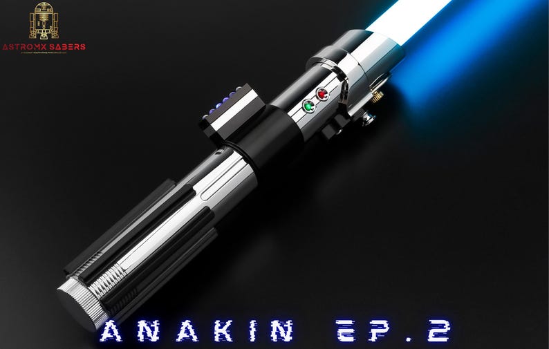 May include: A silver and black lightsaber with a bright blue blade, angled across a black surface. The hilt features buttons and a control panel. The text "ANAKIN EP.2" is at the bottom. The Antromx Sabers logo is in the upper left corner.