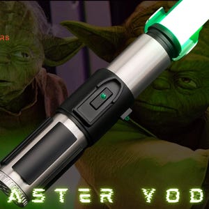 May include: A silver and black lightsaber with a bright green blade, labelled "Master Yoda." The background features a green-skinned character. The text "Astromx Sabers" is in the upper left corner.