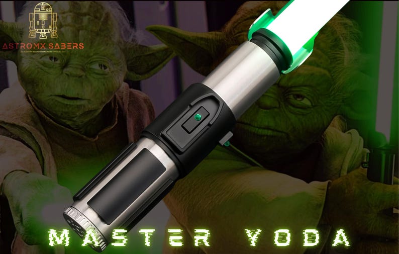 May include: A silver and black lightsaber with a bright green blade, labelled "Master Yoda." The background features a green-skinned character. The text "Astromx Sabers" is in the upper left corner.