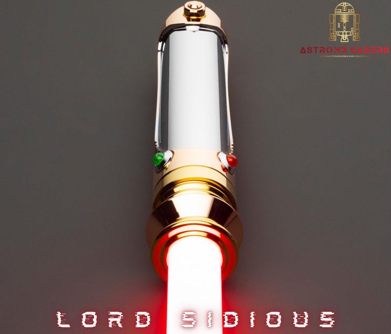 May include: A gold and silver lightsaber with a red blade, the words "LORD SIDIOUS" are displayed at the bottom. The lightsaber has green and red buttons. The top of the lightsaber has a gold design.