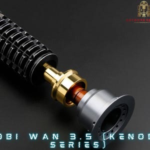 May include: Close-up of a disassembled lightsaber hilt, showing the different components. The hilt is black with a silver and gold accent. The text "OBI WAN 3.5 (KENOBI SERIES)" is visible at the bottom of the image.
