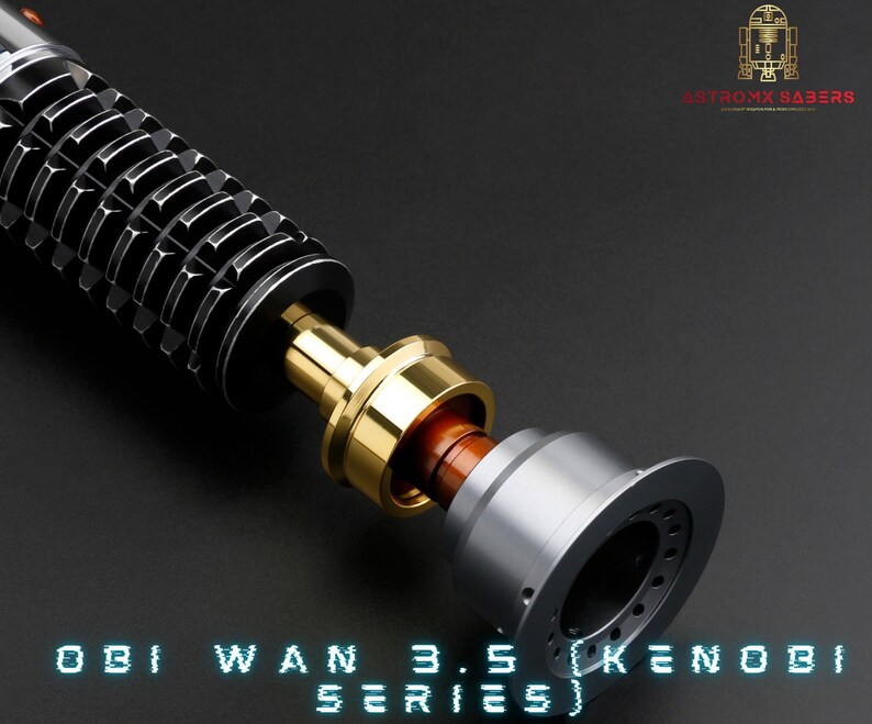 May include: Close-up of a disassembled lightsaber hilt, showing the different components. The hilt is black with a silver and gold accent. The text "OBI WAN 3.5 (KENOBI SERIES)" is visible at the bottom of the image.