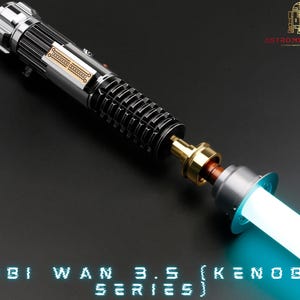 May include: A disassembled lightsaber with a silver and black hilt, a gold connector, and a blue blade. The hilt has a silver band with the text "Obi Wan 3.5 (Kenobi Series)".