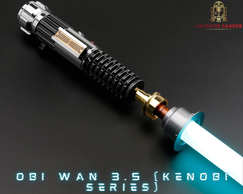May include: A disassembled lightsaber with a silver and black hilt, a gold connector, and a blue blade. The hilt has a silver band with the text "Obi Wan 3.5 (Kenobi Series)".