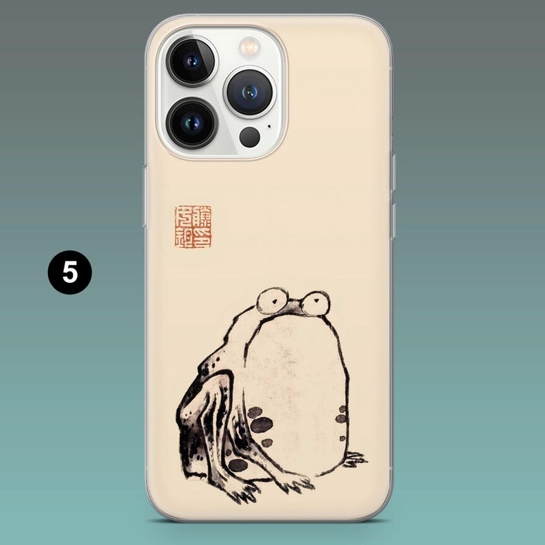 Pode incluir: Capa de telem&oacute;vel com uma ilustra&ccedil;&atilde;o de um sapo no estilo da pintura a tinta japonesa. O sapo &eacute; retratado a preto e branco com manchas escuras. A capa tem um fundo bege e um pequeno selo vermelho.