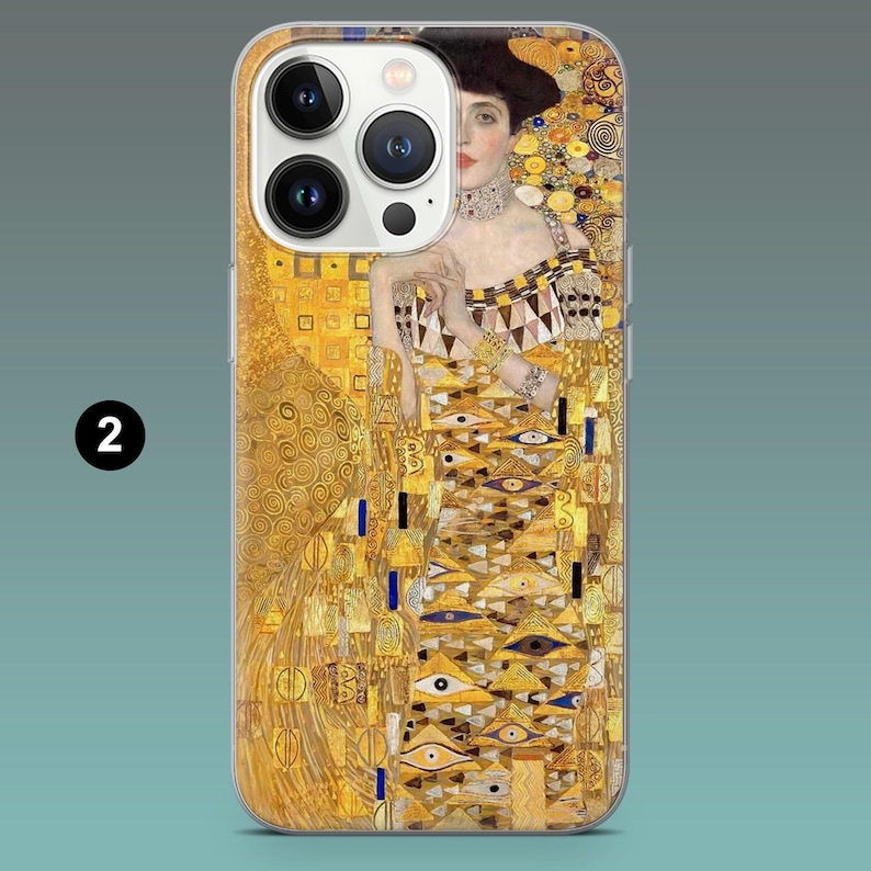 May include: A phone case featuring a portrait by Gustav Klimt. The artwork depicts a woman in a gold and yellow dress with intricate patterns. The case has a clear border and the number "2" is visible on the lower left.