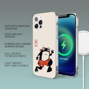 Pode incluir: Capa de telefone creme com um desenho de um sapo de cal&ccedil;&otilde;es vermelhos. O ecr&atilde; do telefone mostra um s&iacute;mbolo de carregamento. O texto na capa diz: Suporta carregamento sem fios, as laterais n&atilde;o s&atilde;o impressas, p&aacute;ra-choques do ecr&atilde; e da c&acirc;mara elevados.