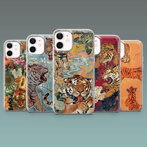 May include: A collection of five phone cases with vibrant tiger illustrations. Each case features a unique design, including tigers in various poses, set against floral, abstract, and nature-inspired backgrounds. The cases have clear edges.