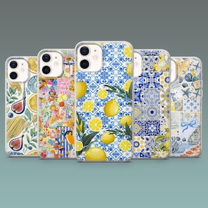 May include: A collection of five phone cases with various designs. The cases feature patterns including lemons, floral arrangements, and blue and white tile motifs. Each case has a clear border and a camera cutout.