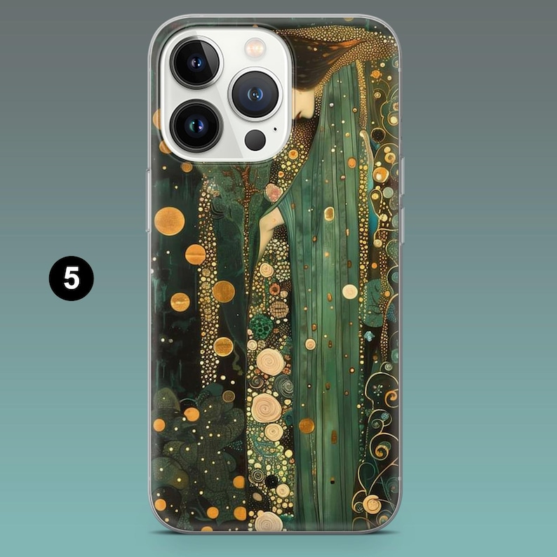 May include: A phone case featuring an art nouveau design with a woman in a flowing green gown. The artwork includes gold and bronze accents, with circular and organic patterns. The case has a clear border and a camera cutout.