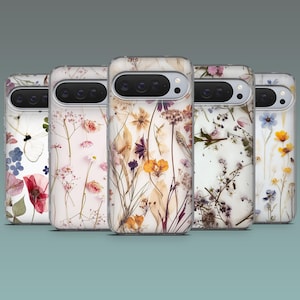 May include: Five phone cases with floral designs. Each case features a different arrangement of dried flowers in various colors, including red, pink, yellow, and blue, set against a white background. The cases have a clear, glossy finish.