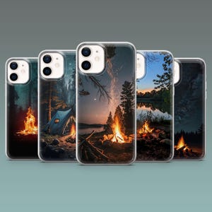 May include: Five phone cases showcasing camping scenes. Each case depicts a different nighttime landscape with a campfire, trees, and a tent. The cases have a clear border and a glossy finish.